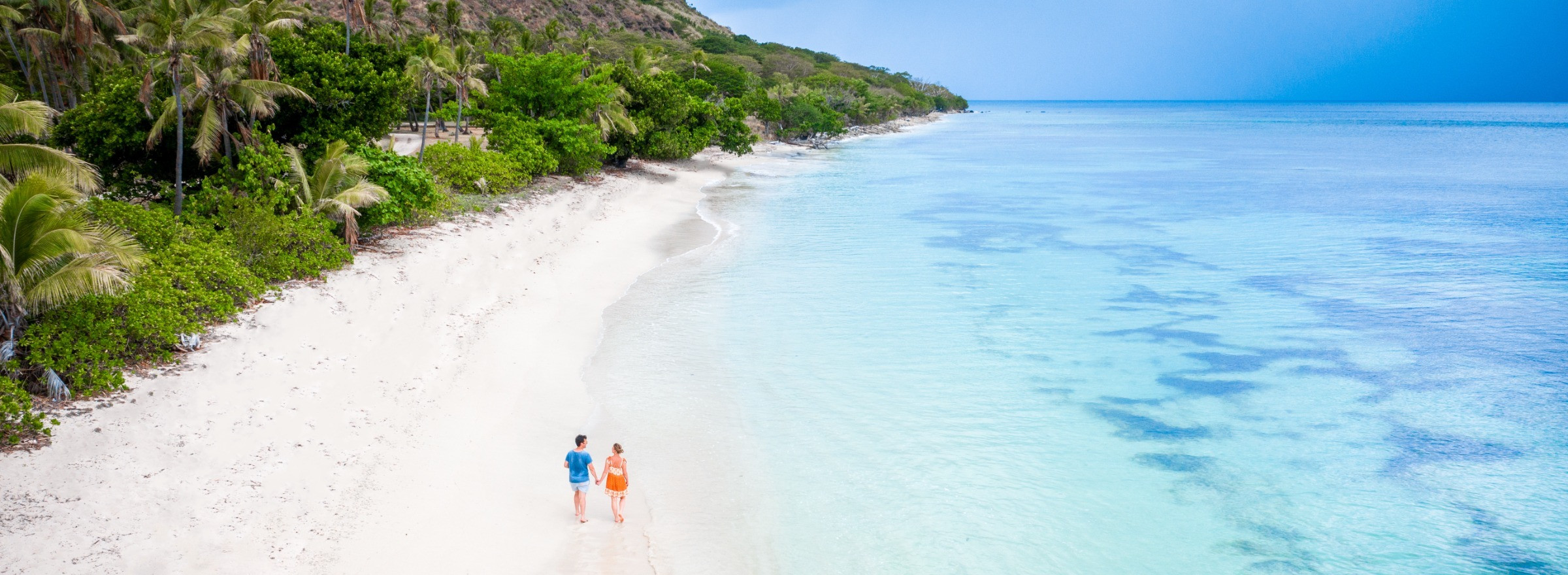 couple walking on a beach in Fiji