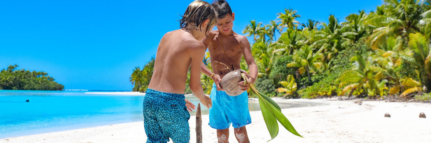 husking coconuts in Rarotonga
