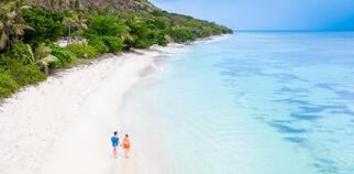 couple walking on a beach in Fiji