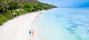 couple walking on a beach in Fiji
