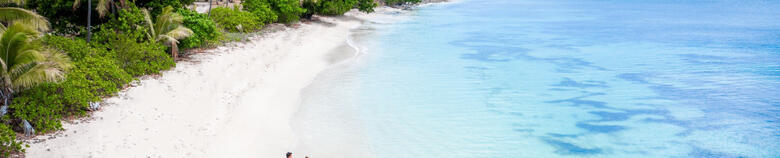 couple walking on a beach in Fiji