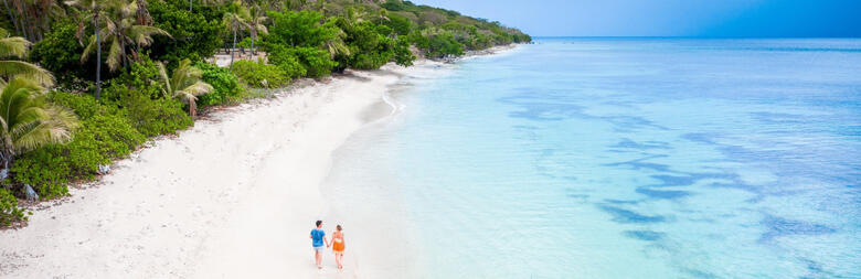 couple walking on a beach in Fiji