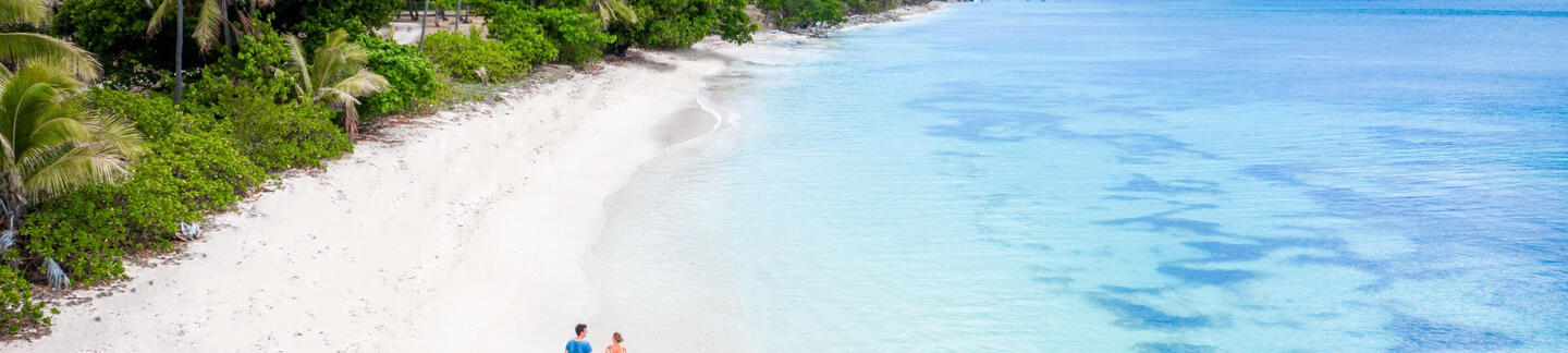 couple walking on a beach in Fiji