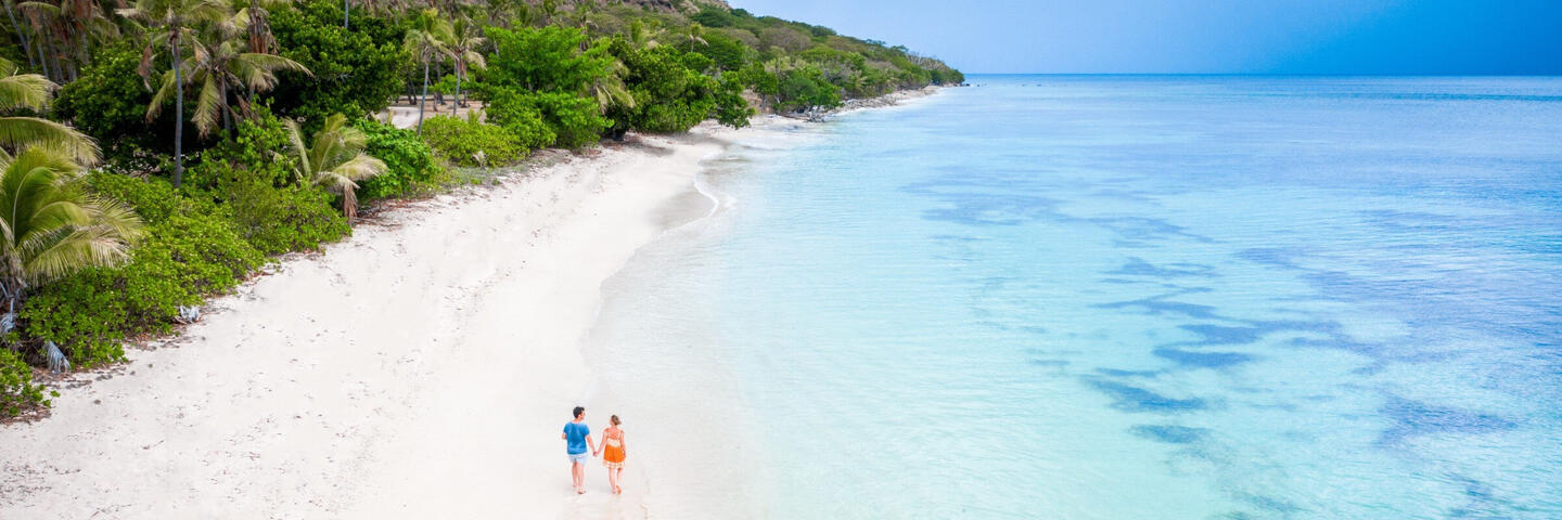 couple walking on a beach in Fiji