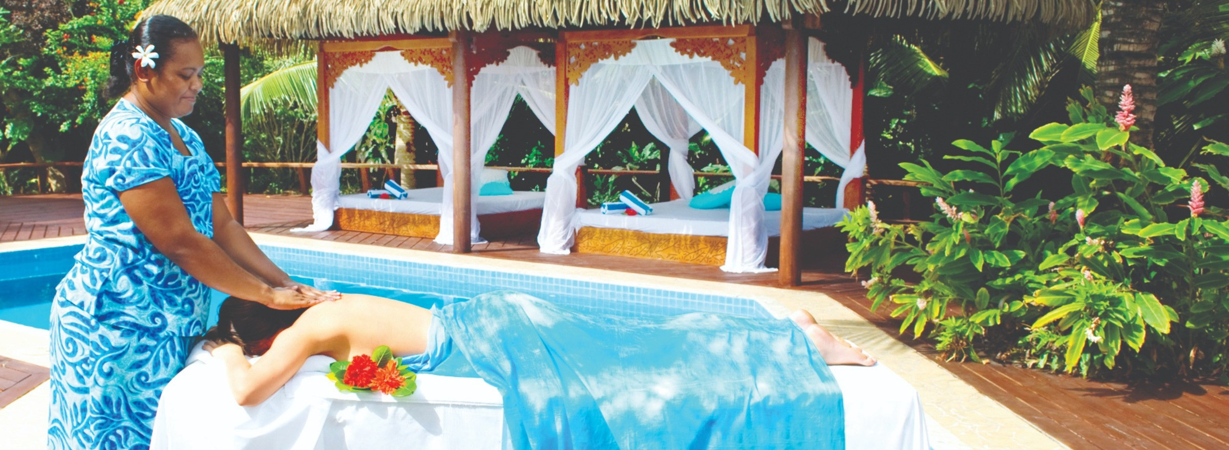 image of woman receiving massage near pool at Sanctuary Resort Rarotonga