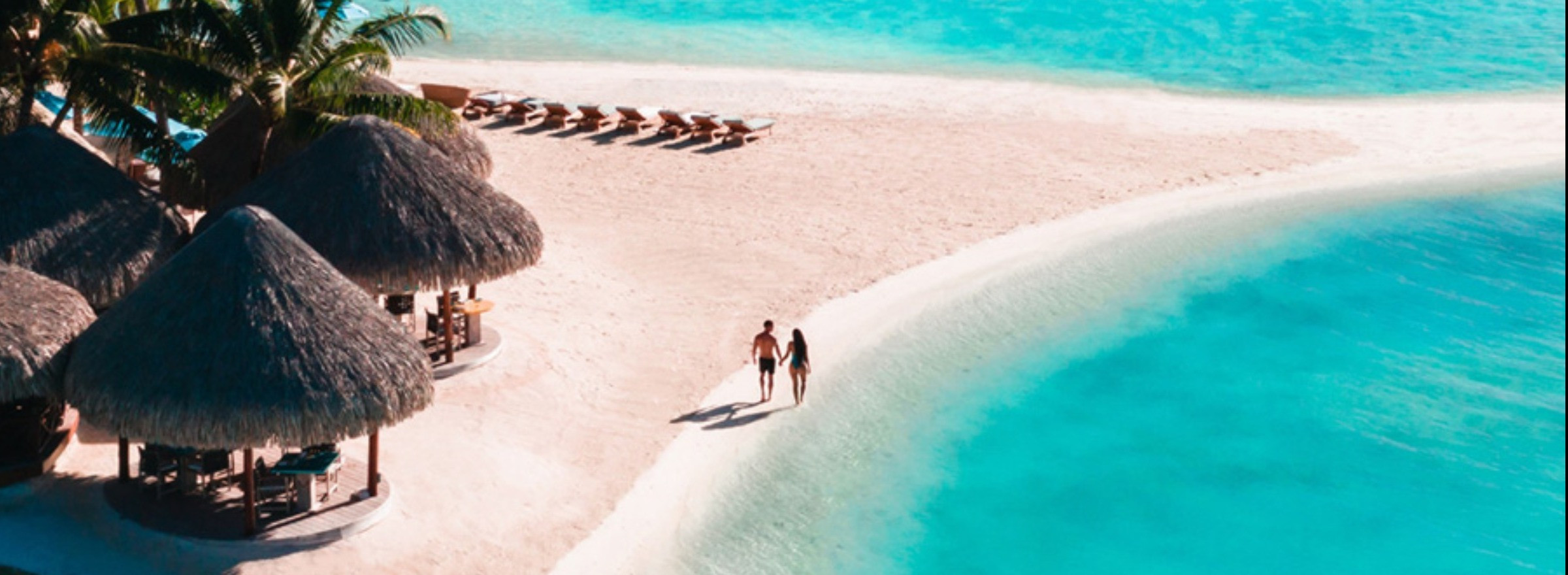 couple walking on beach in Bora Bora