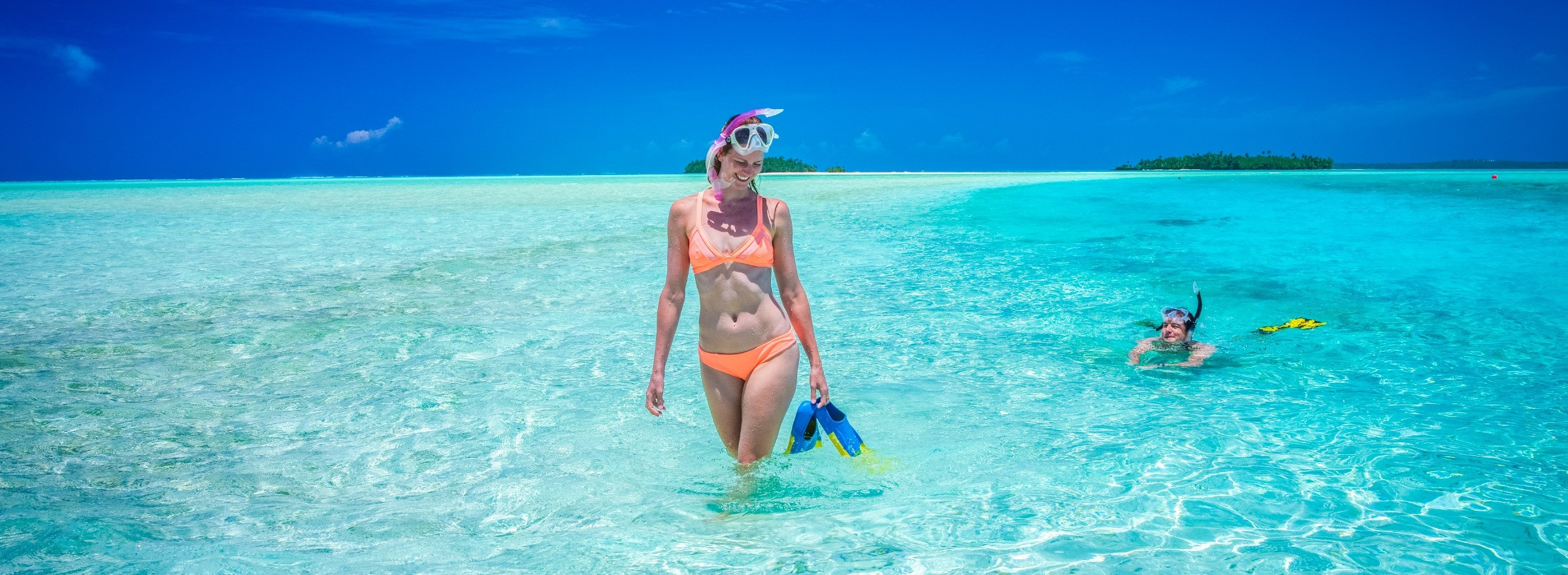 woman holding snorkels in Cook Islands