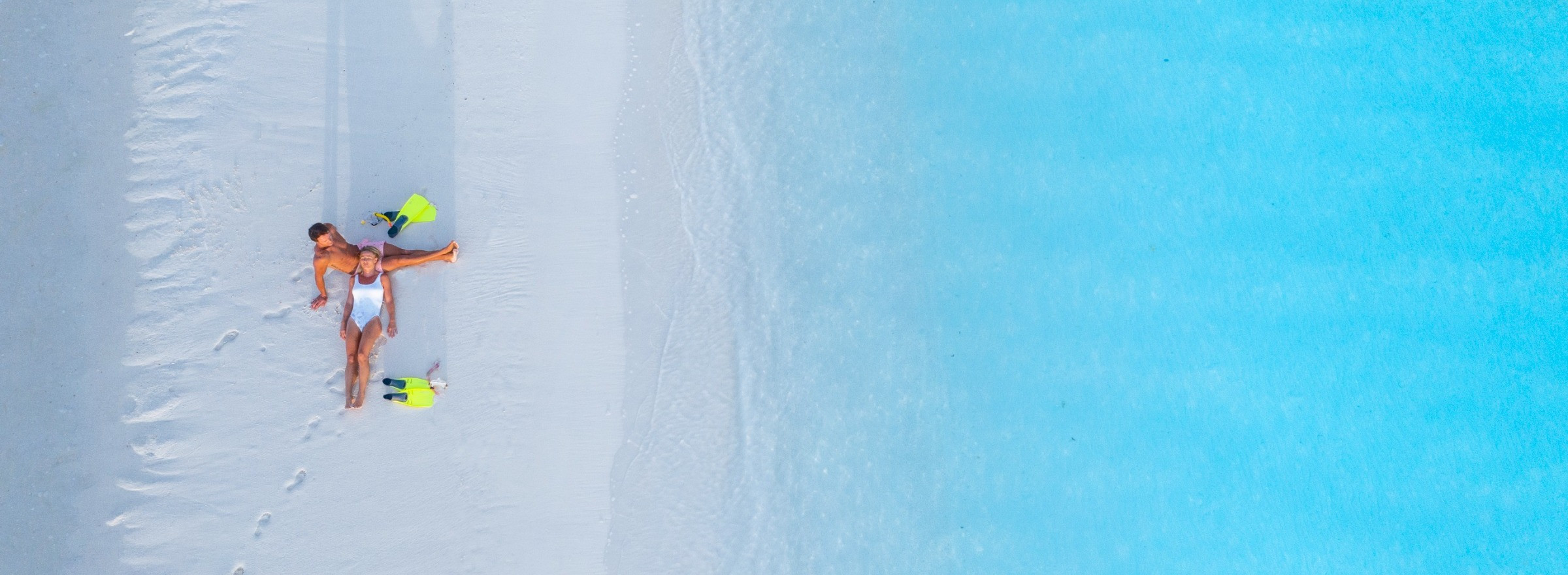 couple laying on beach in Cook Islands