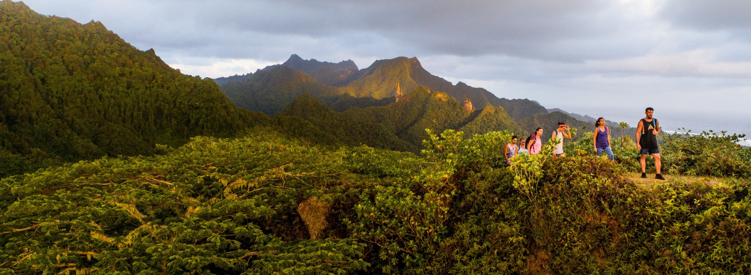 Adventurers climb a mountain on Rarotonga