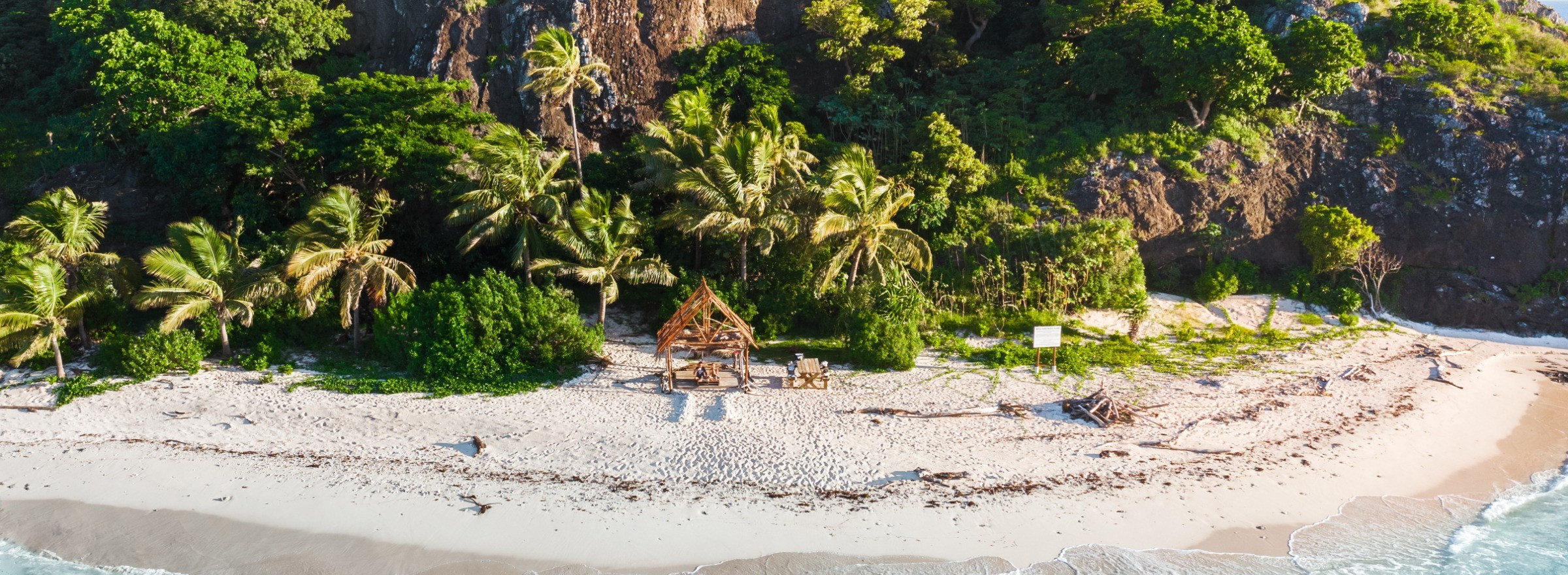 Photo of beautiful coastal beach with waves lapping against stunning white sand