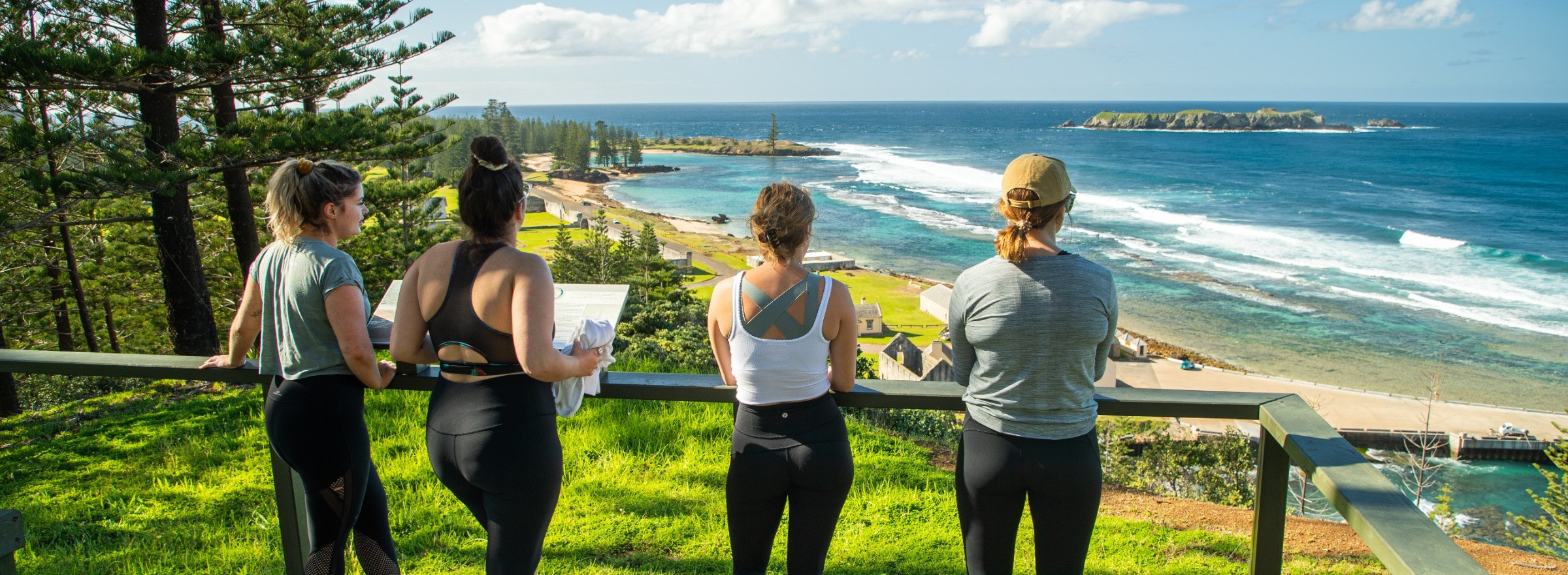 image of four women hiking with a view of the ocean