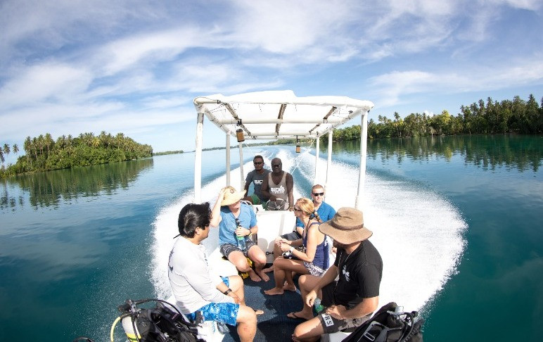 people on boat in Vonavona lagoon Solomon Islands
