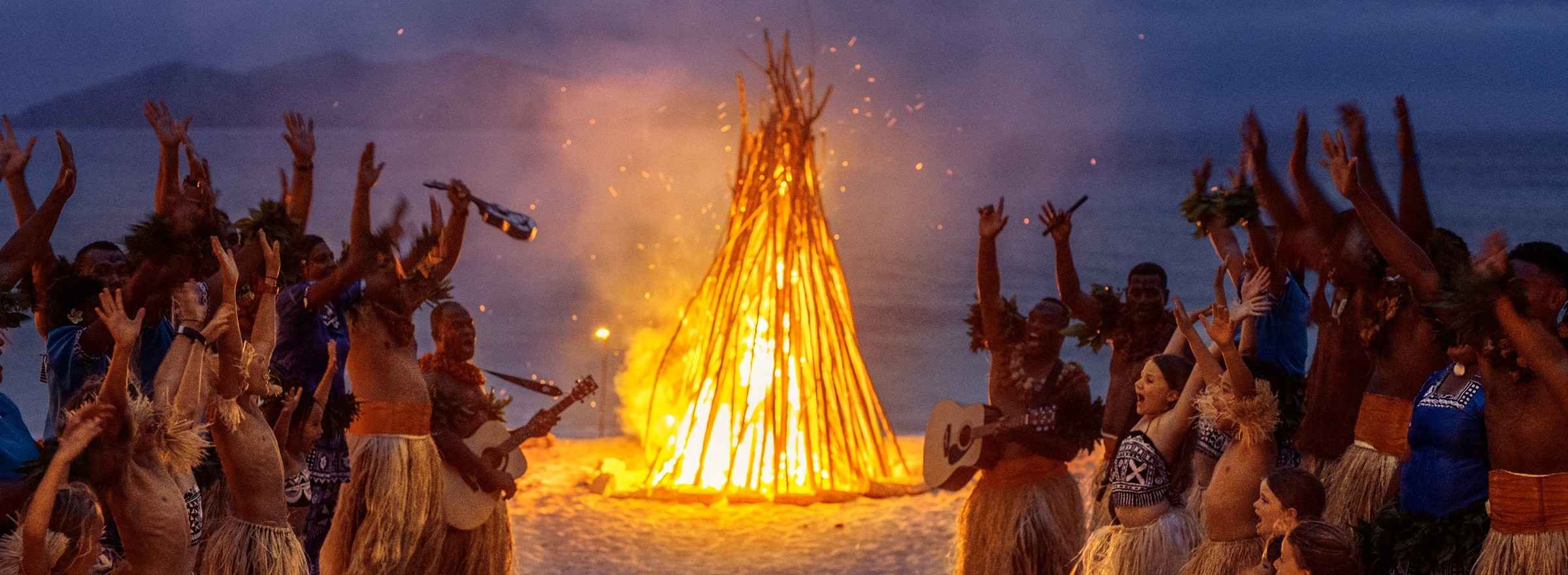 Fijian Locals celebrating with Kava, Dancing and Fire