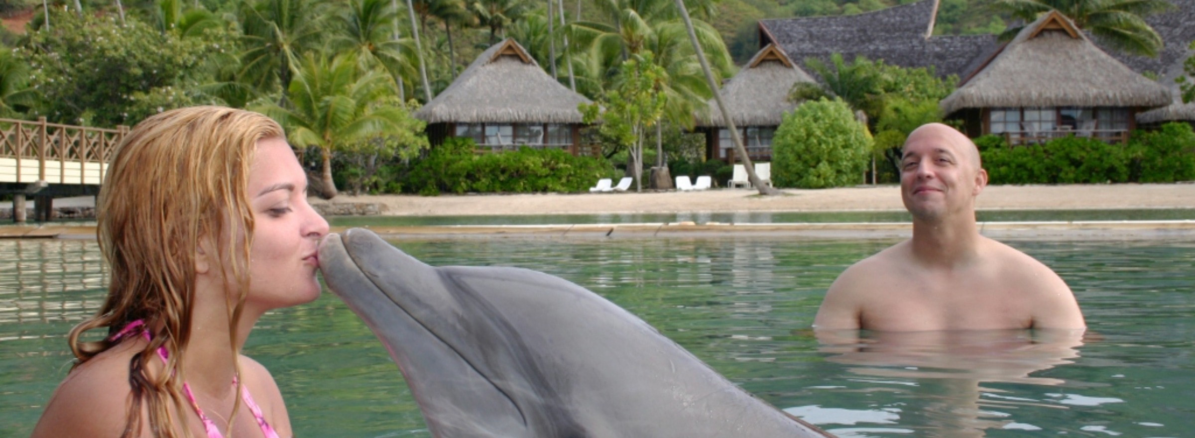 woman kissing dolphin Moorea