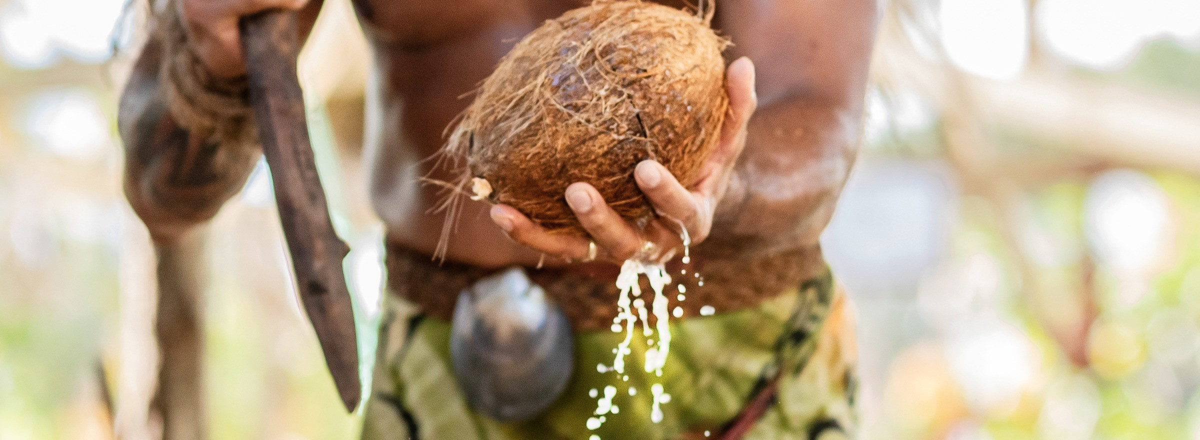 man opening a coconut