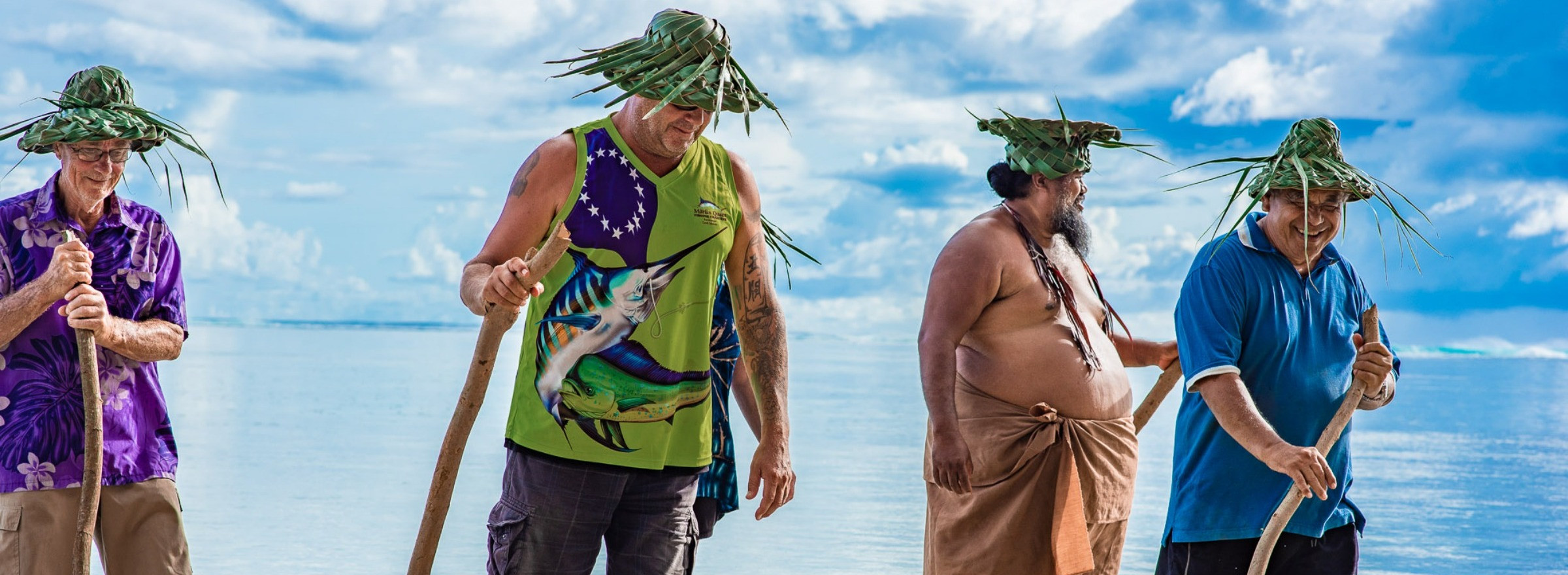 Image of a group in traditional grass hats